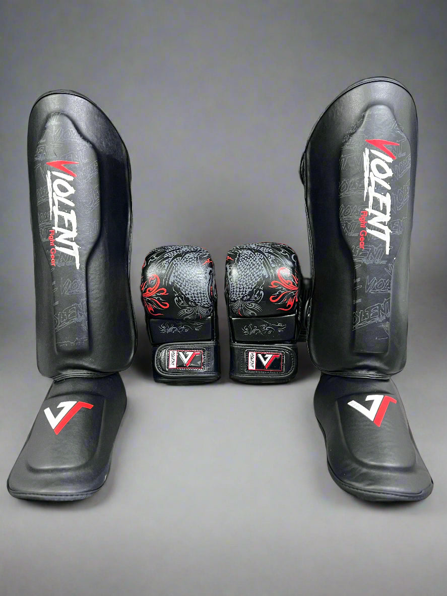 Pair of black shin guards and black gloves with 'Violent' branding on a textured gray background.